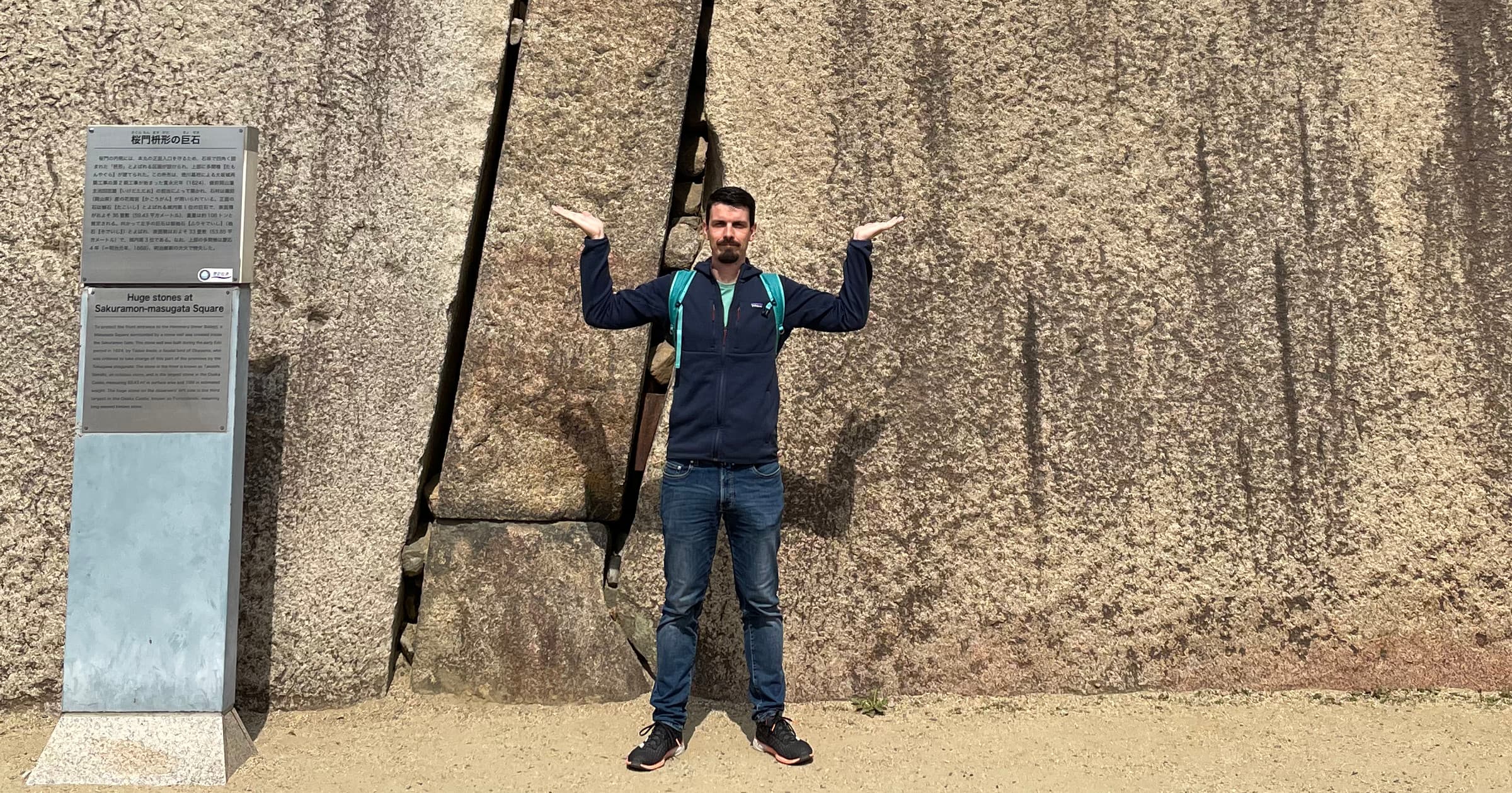 In front of the wall of Osaka Castle, Japan.